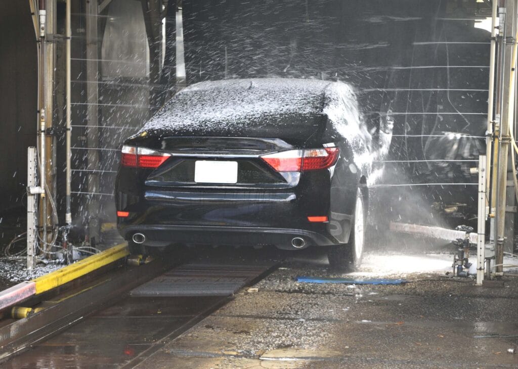 Black car getting sprayed with water